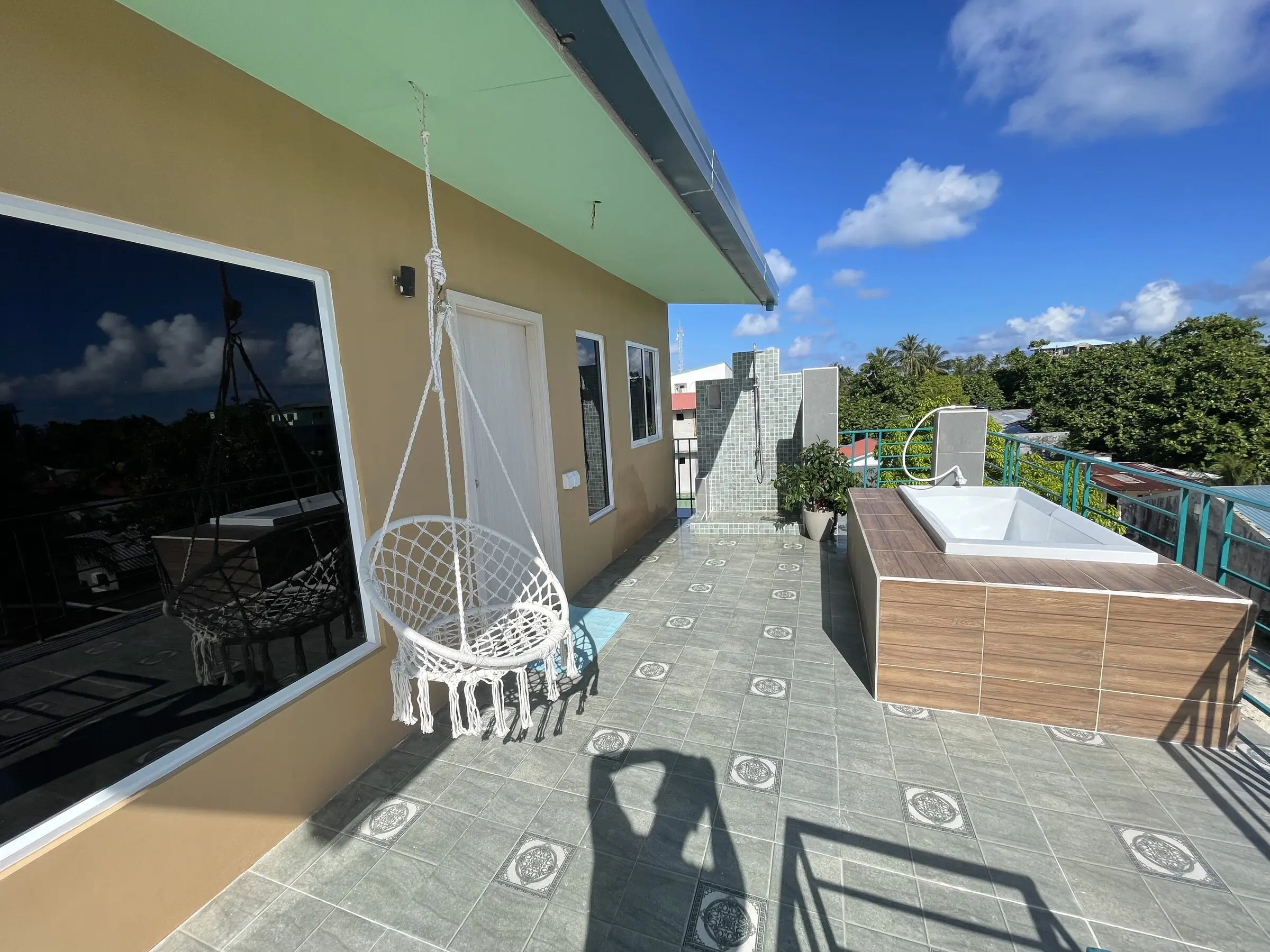 Private terrace with a hanging chair at dusk at Koimala Maamigili