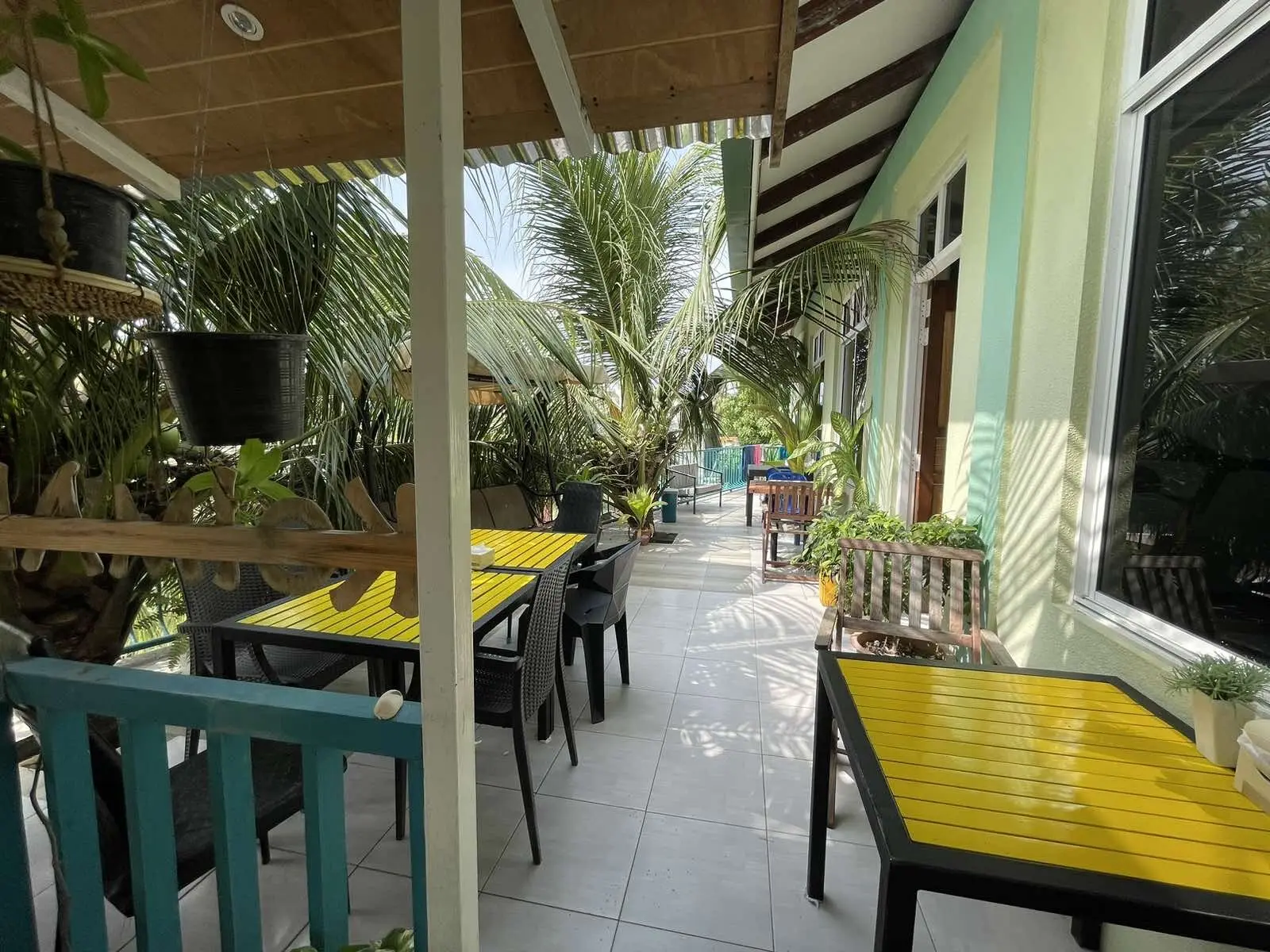 Open-air dining terrace with yellow chairs at Koimala Maamigili
