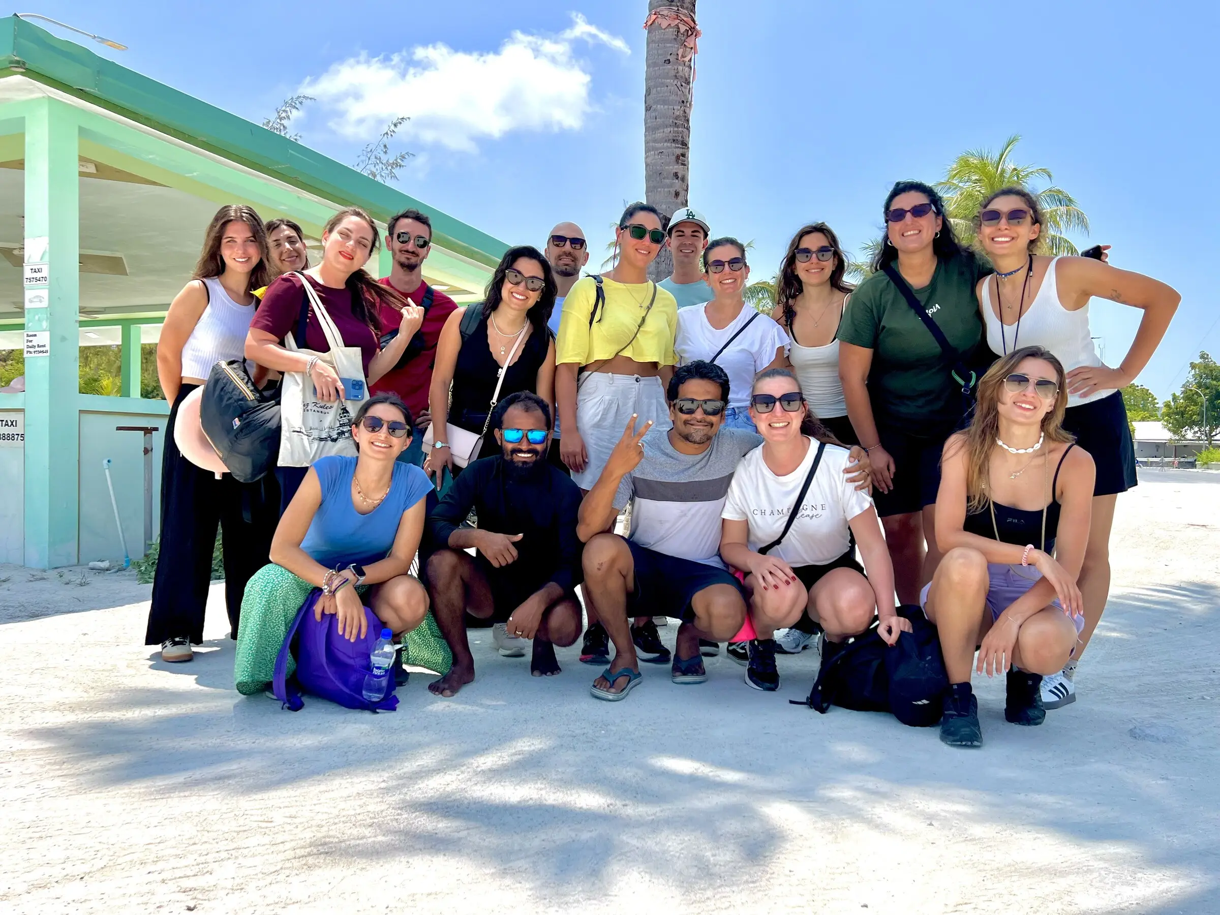Group of guests together on Maamigili beach